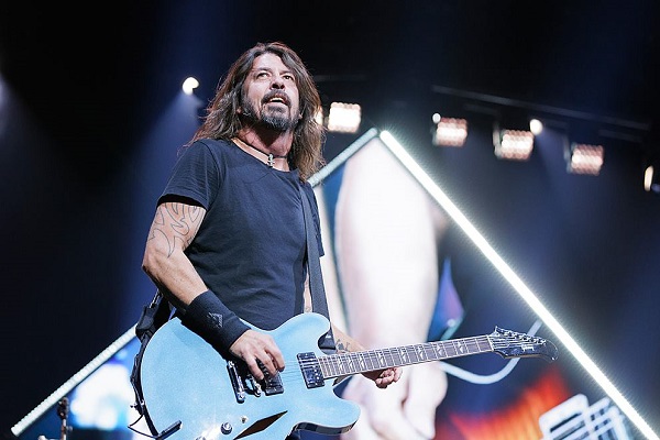 Dave Grohl of Foo Fighters performing with his baby blue, Gibson ES-335.