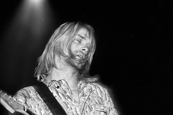 A classic photo of Kurt Cobain performing live in the early 1990s.