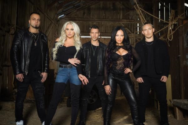 Butcher Babies promo photo, featuring the band in a rustic setting.