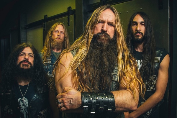 The member of Black Label Society standing in a dark room. It's the band's 2021 press photo.