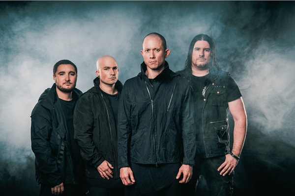 Trivium band photo, featuring the band standing amid a dark, smoky background.