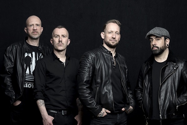 Danish metal band Volbeat standing for a press photo.