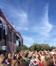 Fans crowd the stage during a popular summertime music festival.