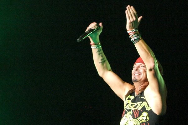 Poison frontman Bret Michaels clapping his hands and performing at DTE Energy Music Theatre in Clarkston, Michigan, in 2018. Tour 2018