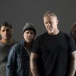 Metallica promo photos, featuring James Hetfield, Kirk Hammett, Lars Ulrich and Robert Trujillo, dressed in black and gray.