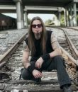 Todd La Torre of Queensryche, posted on railroad tracks on a dark day. La Torre has a new solo album out, "Rejoice in the Suffering."