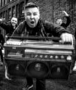 Dropkick Murphys pictured on a city street, in black and white.