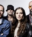Promo photo of metal band Baroness, with band members standing amid a white background.
