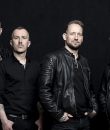 Danish metal band Volbeat standing for a press photo.