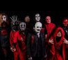 Image of metal band Slipknot standing against a black background