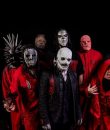Image of metal band Slipknot standing against a black background