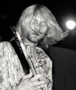 A black and white photo of Kurt Cobain of Nirvana.