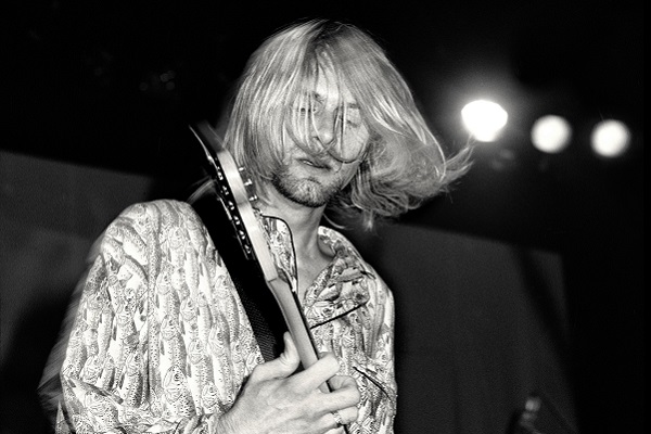 A black and white photo of Kurt Cobain of Nirvana.