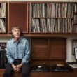 Photo of Paul McCartney sitting in a library.