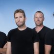 Image of the rock band Nickelback with a blue background.
