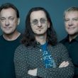 Photo of the Canadian rock band Rush, with a blue background.