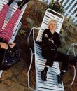 Image of the band Green Day on a summer deck lying in chairs.