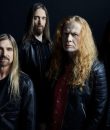 Metal band Megadeth posting in darkness.