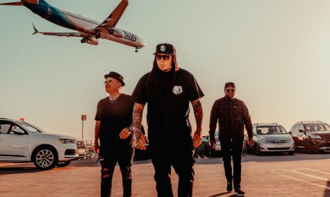 Nu-metal band P.O.D. walking outside with an airplane behind them.