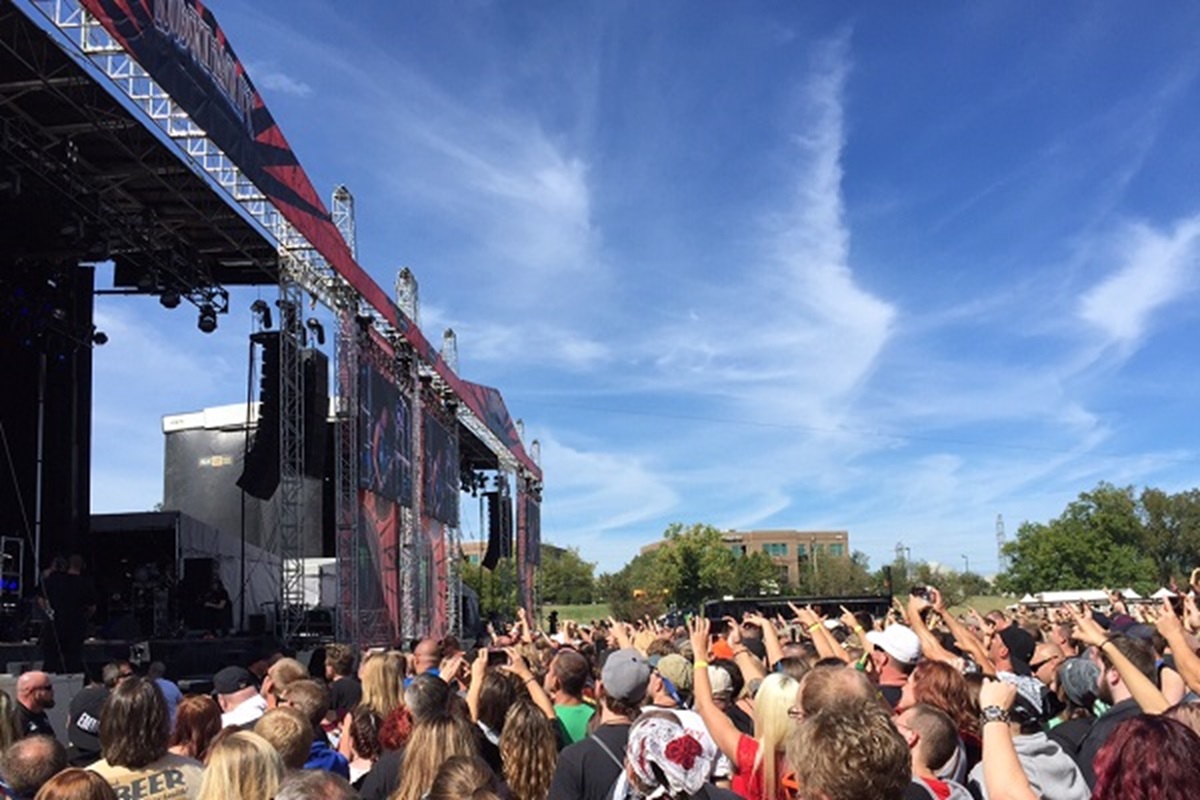 Fans at an outdoor music festival with blue skies. Each year, Live National launches its Concert Will, offering Live Nation $25 tickets to hundreds of concerts.
